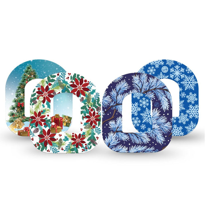 Four decorative holiday-themed Omnipod tapes arranged in a row on a white background. The designs include a Christmas tree scene, a red poinsettia wreath, and two blue pine-bark and snowflake patterns.