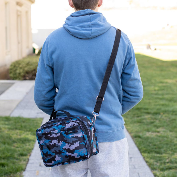 Boy wearing a digital camo travel bag on his shoulder, highlighting its rugged and modern design.