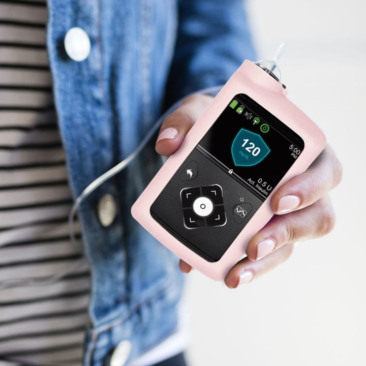 Women holding light pink Medtronic Insulin Pump Gel Skin with Medtronic pump in it. 