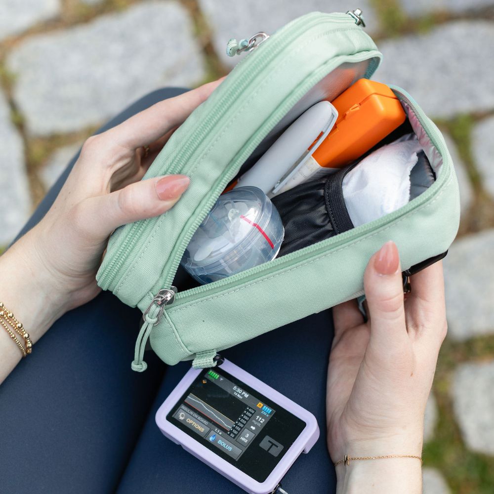 Seafoam Supply Case with diabetes supply held by a person outdoors.