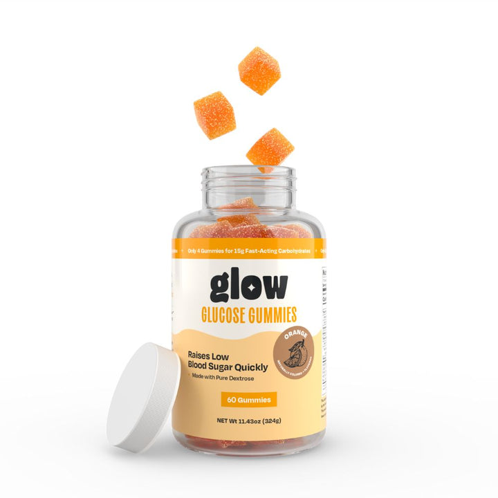 Bottle of orange glow gummies with three gummies coming out of the top. 