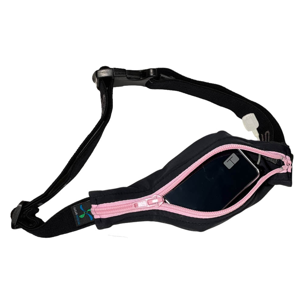 Black stretchy waist belt with light pink zipper unzipped with insulin pump shown along with tubing coming out of the slit on the back side for easy access.