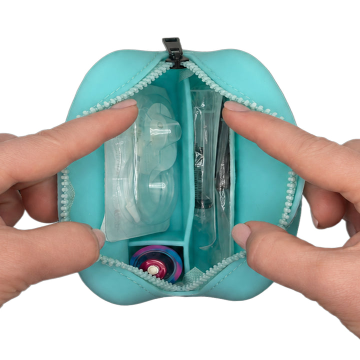 Aqua Tandem Protective Travel Case with Tandem supplies, held open by hands on a white background