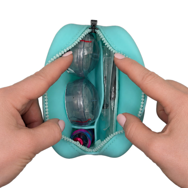 Aqua Tandem Protective Travel Case with Tandem supplies, held open by hands on a white background