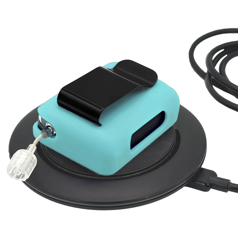 Aqua Tandem Mobi EZ-To-Charge Clip with Mobi insulin pump inside the case, lying flat on charger.