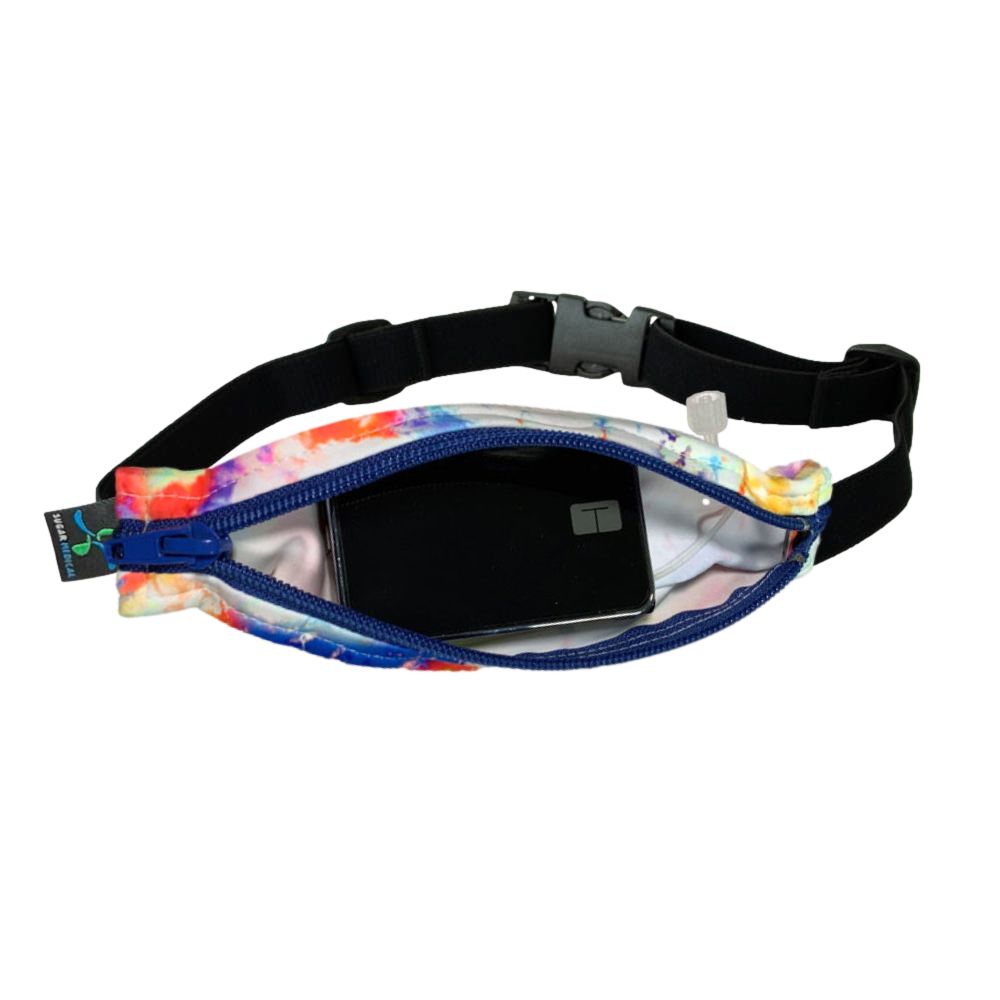 Kids colorful tie dye pattern with blue zipper SPI belt open with Tandem pump inside and tubbing coming out the side hole.