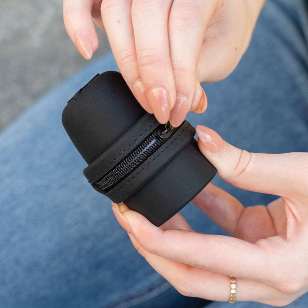 Person holding a black Libre 3 Travel Protective case with a zipper.