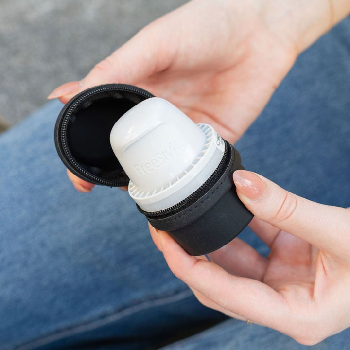 Person holding a black Libre 3 Travel Protective case.