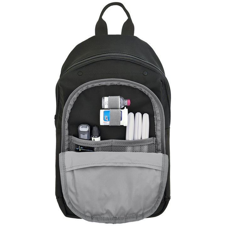 Black and gray backpack with diabetes supplies organized in front pocket on a white background.