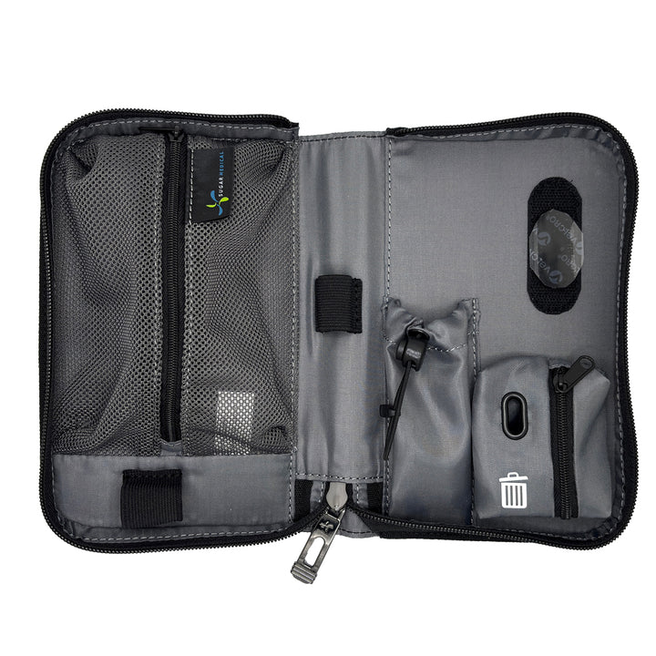 An open gray and black organizer pouch with multiple compartments, mesh pockets, elastic loops, and a small trash-compacting pocket, shown on a white background.