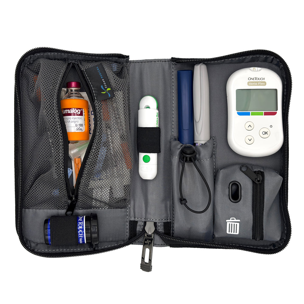 An open gray and black medical organizer pouch containing various diabetes management tools, including a white OneTouch glucose meter, pens, a thermometer, and storage compartments, shown on a white background.