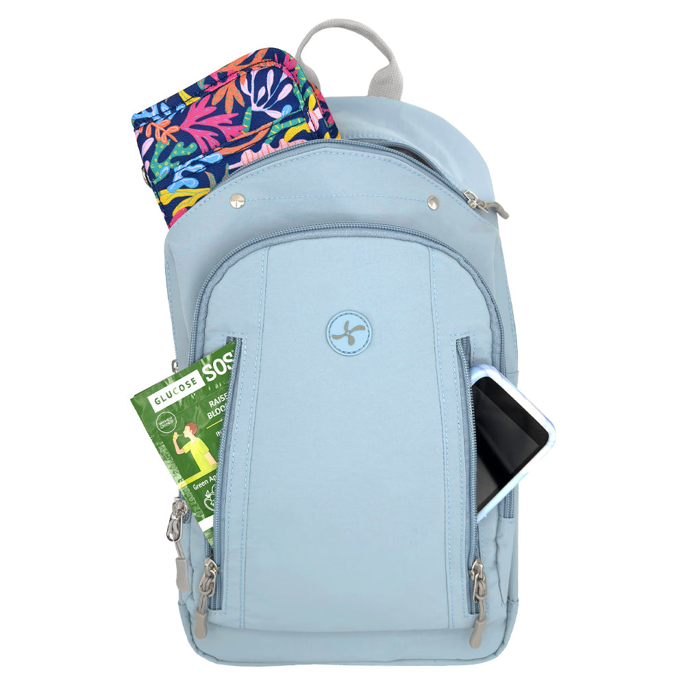 A light blue backpack shown on a white background, filled with various items including a diabetes supply case, glucose, and a Omnipod 5 PDM in its side pocket.
