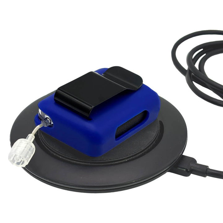 Blue Tandem Mobi EZ-To-Charge Clip with Mobi insulin pump inside the case, lying flat on a charger