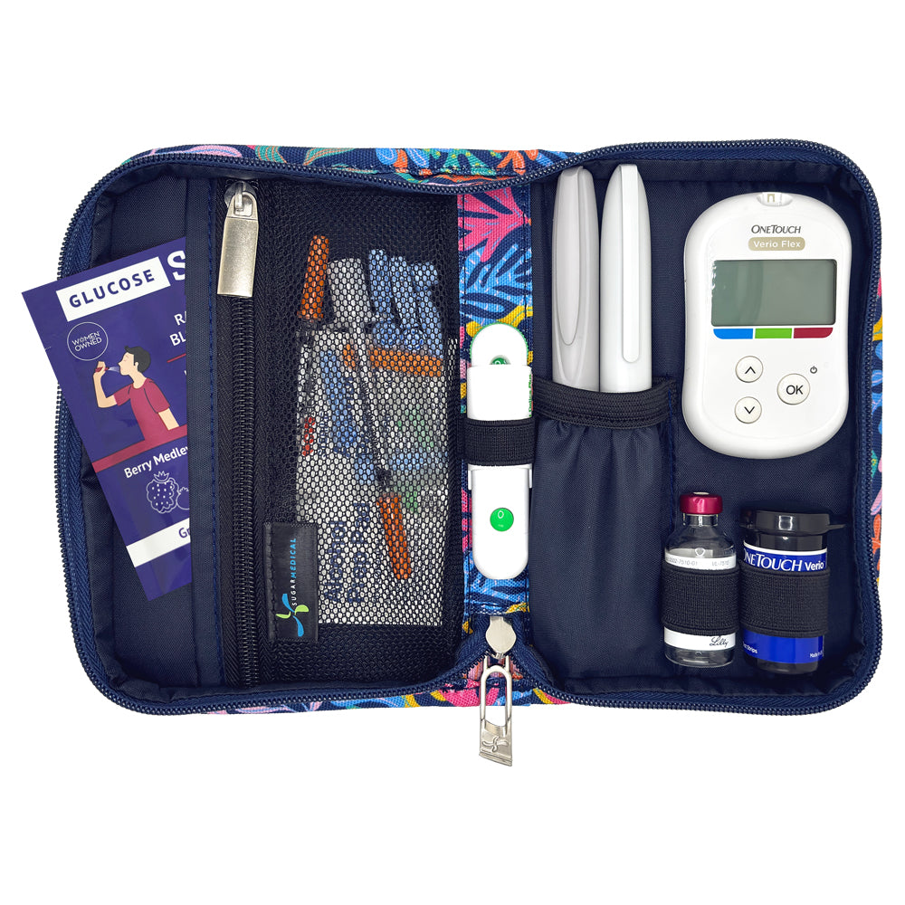 A diabetes management kit in a zippered organizer case, shown open against a white background. The kit contains a OneTouch Plus glucose meter, two lancets, two small bottles, a meter clip, a pen-style device, mesh storage pockets, and a brochure.