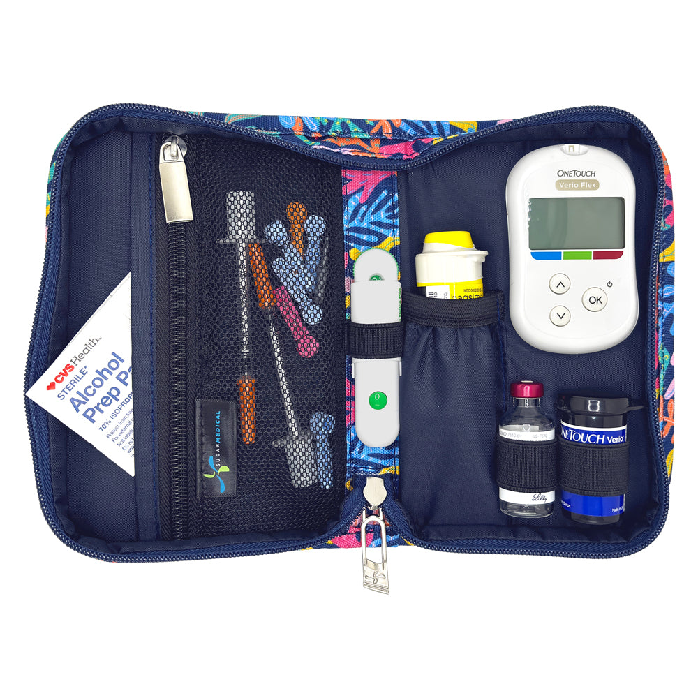 A colorful zippered medical kit organizer shown open on a white background, containing a glucose meter, lancets, test strips, alcohol prep pad, and other small medical supplies.