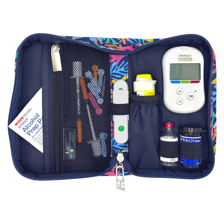 A colorful zippered medical kit organizer shown open on a white background, containing a glucose meter, lancets, test strips, alcohol prep pad, and other small medical supplies.