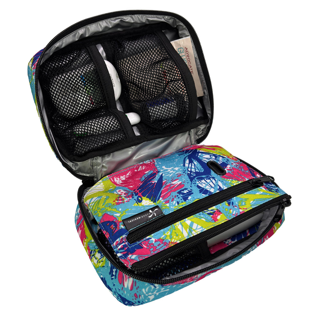 The front section of the pink, blue and green butterfly print diabetes organizer has three mesh pockets to secure your diabetic supplies