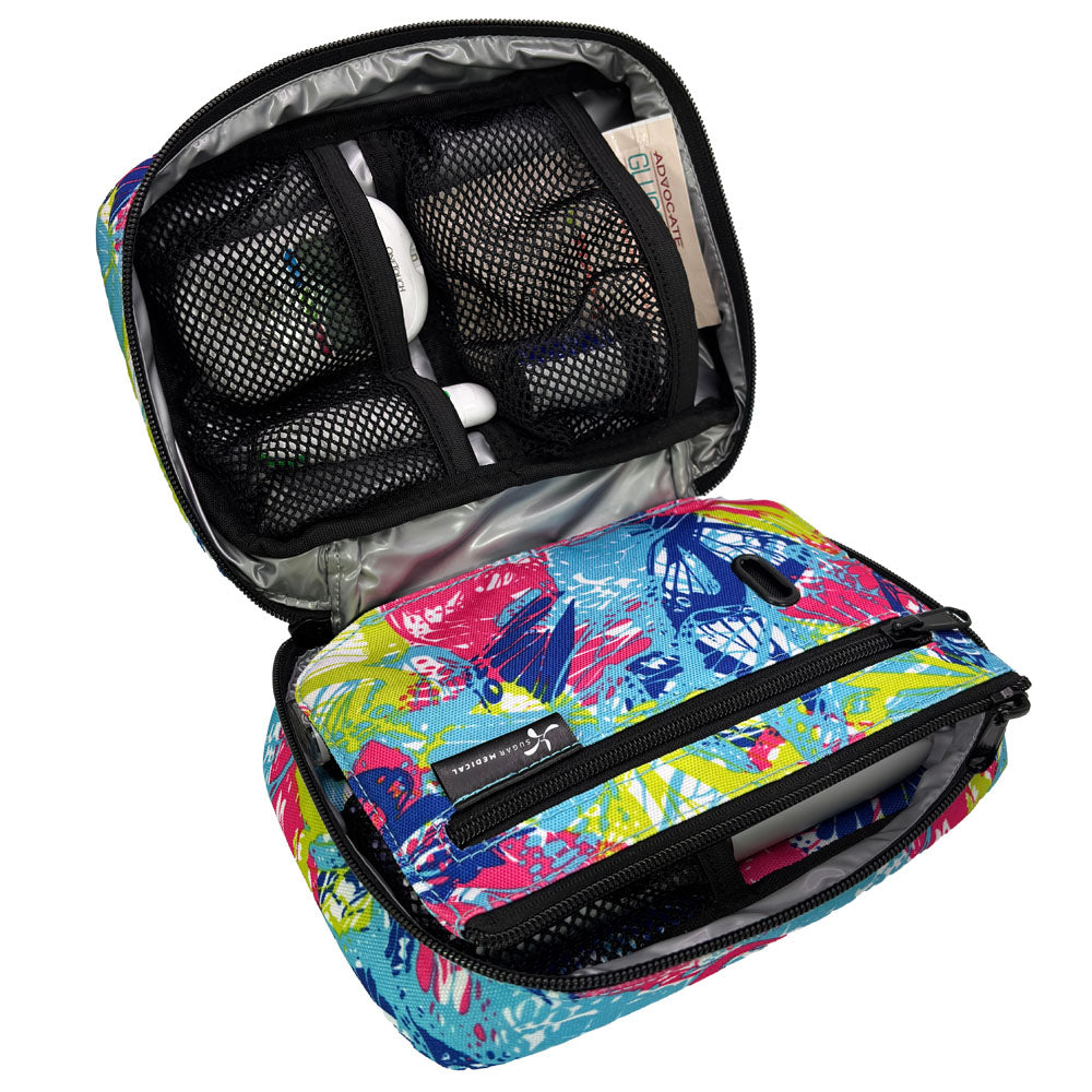 The front section of the pink, blue and green butterfly print diabetes organizer has three mesh pockets to secure your diabetic supplies