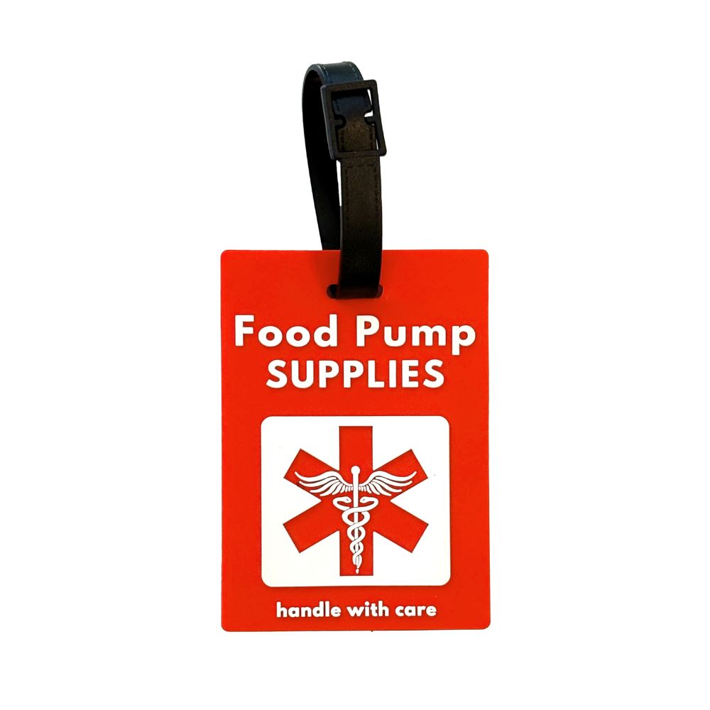 A red luggage tag with a black strap, featuring the text 'Food Pump SUPPLIES' and a white medical-style symbol, with 'handle with care' printed at the bottom.
