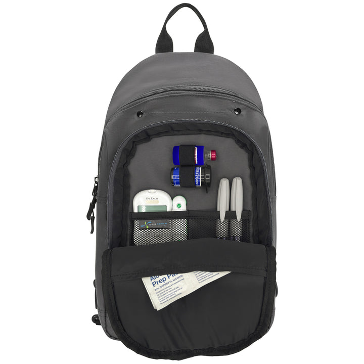A dark gray backpack shown open against a white background, displaying its front organizer pockets filled with various small items such as a thermometer, pens, and a first-aid packet.