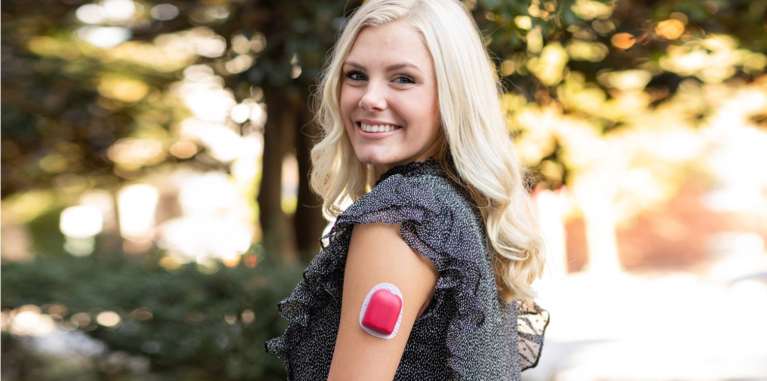 PumpPOPS™ Omnipod Cover in red on a women's arm in red adding color and fun to your pod. 