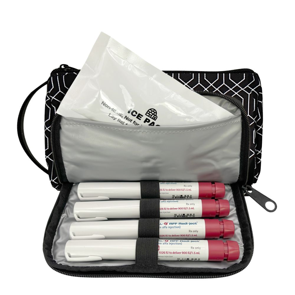 An open black and white patterned zippered travel medical kit pouch containing four insulin pens and a clear plastic protective bag, shown on a white background.