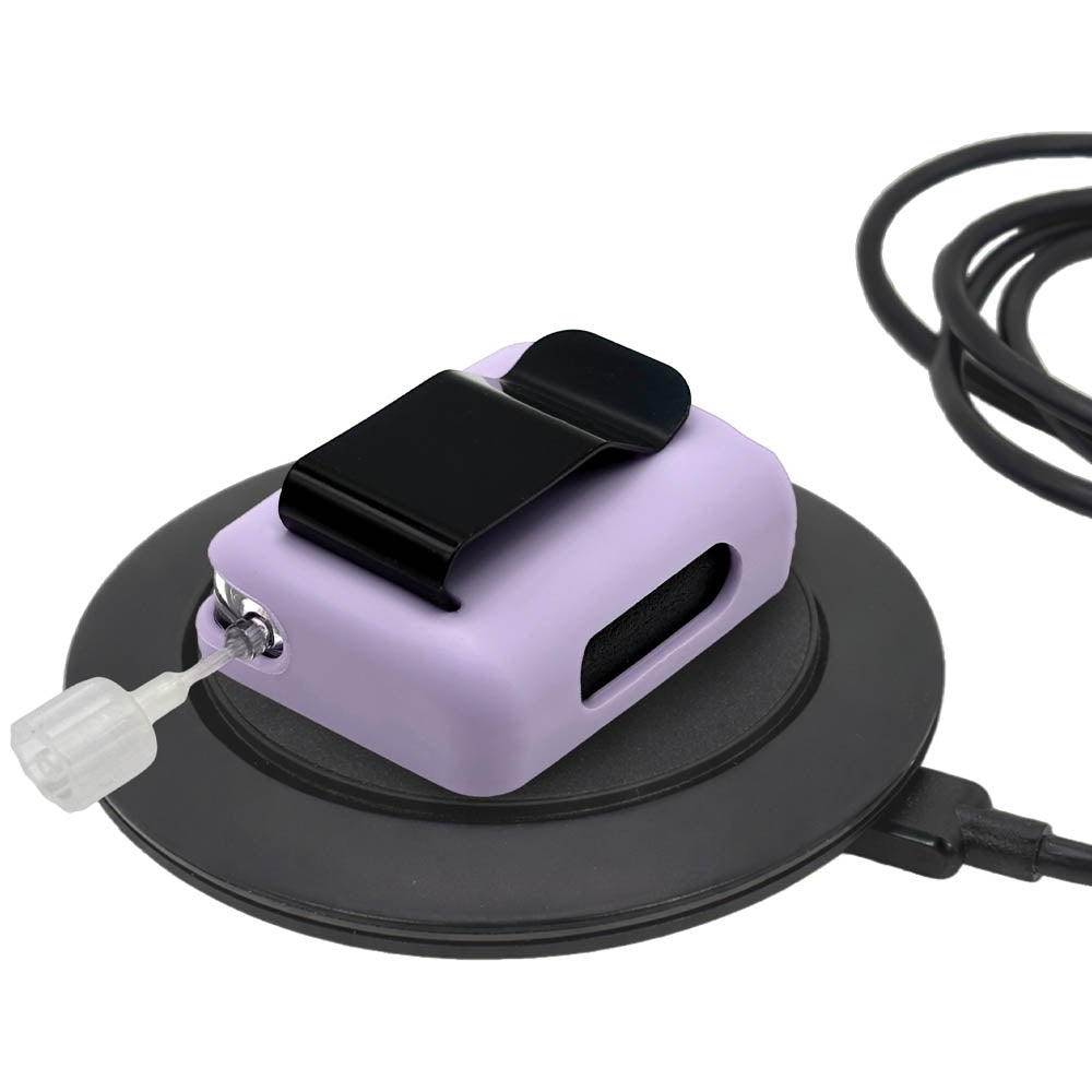 Lavender Tandem Mobi EZ-To-Charge Clip with Mobi insulin pump inside the case, lying flat on charger.