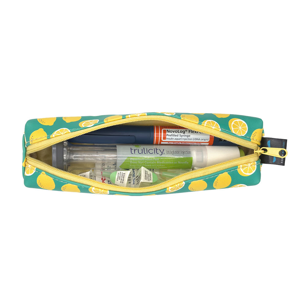 Lemon-patterned slim case open with an insulin pen and GPL-1 pen and pen tips in it. 