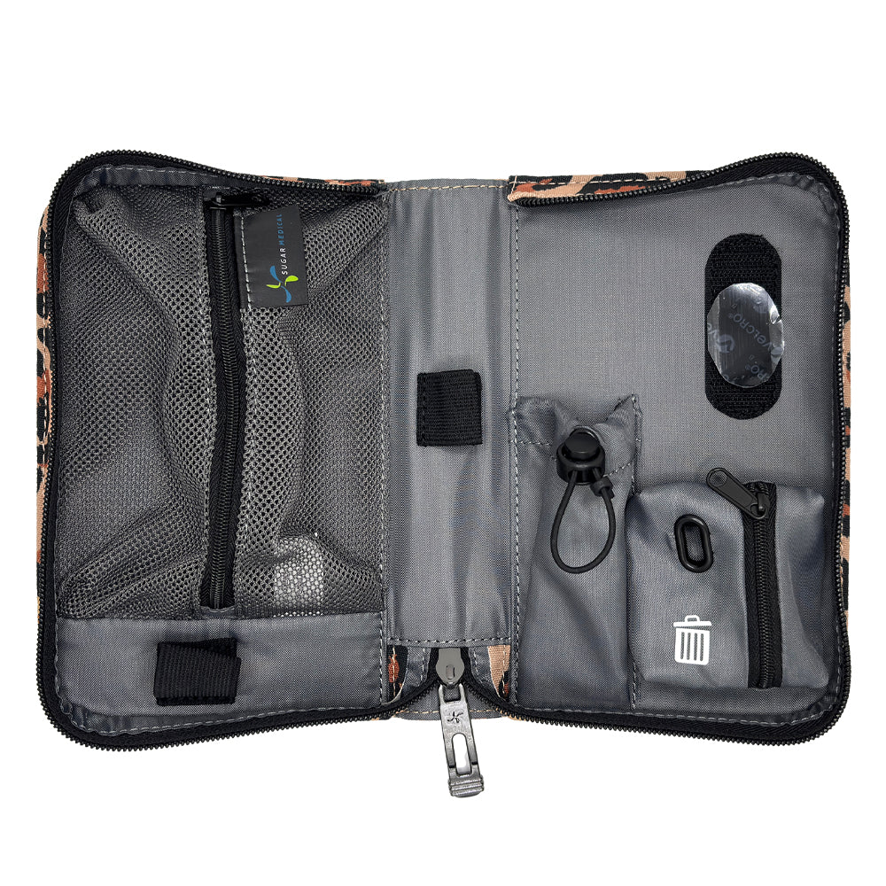 An open gray and black organizer pouch with multiple compartments, mesh pockets, elastic loops, and a small trash-compacting pocket, shown on a white background.