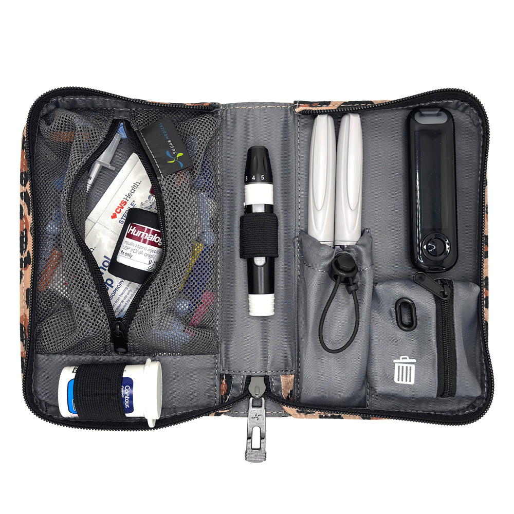 An open gray and black medical organizer pouch containing various diabetes management tools, including a white OneTouch glucose meter, pens, a thermometer, and storage compartments, shown on a white background.