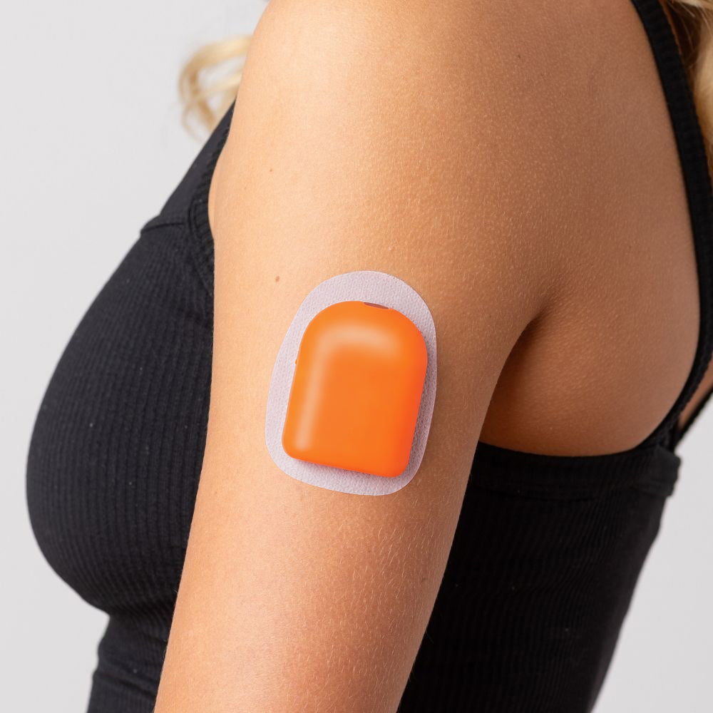 A close-up picture of a woman wearing the orange PumpPOP on the outside of her upper left arm