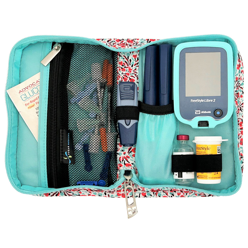 Sugar Medical Diabetes Supply Case II white with teal and red mini flowers inside set up with glucose meter, test strips, lancet, insulin pens and glucose sos. 