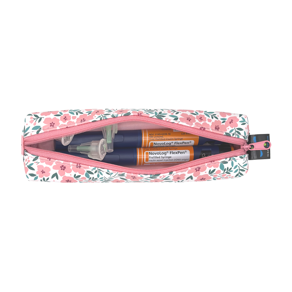 Floral-patterned slim case open with two insulin pens and pen tips in it. 