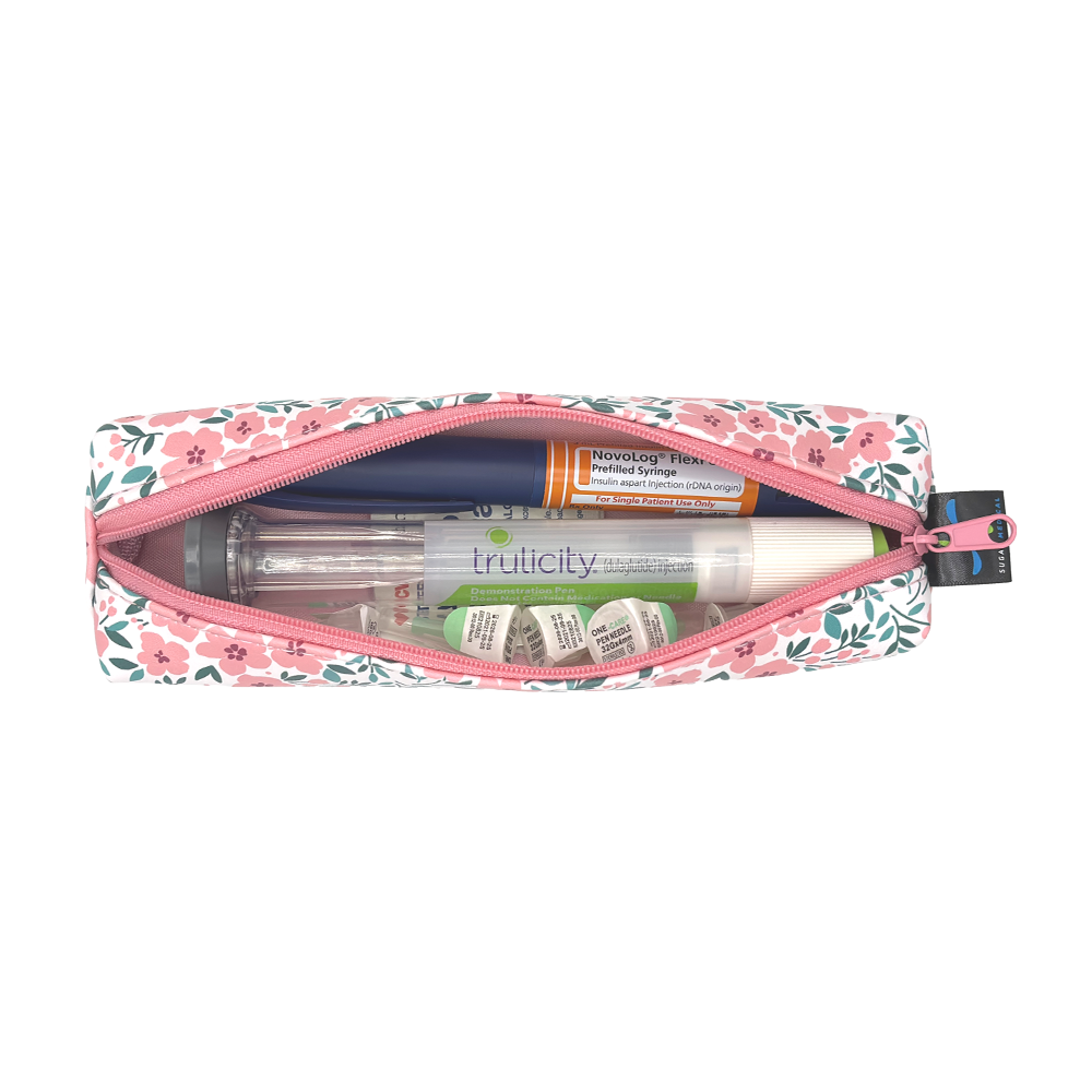 Floral-patterned slim case open with an insulin pen and GPL-1 pen and pen tips in it. 