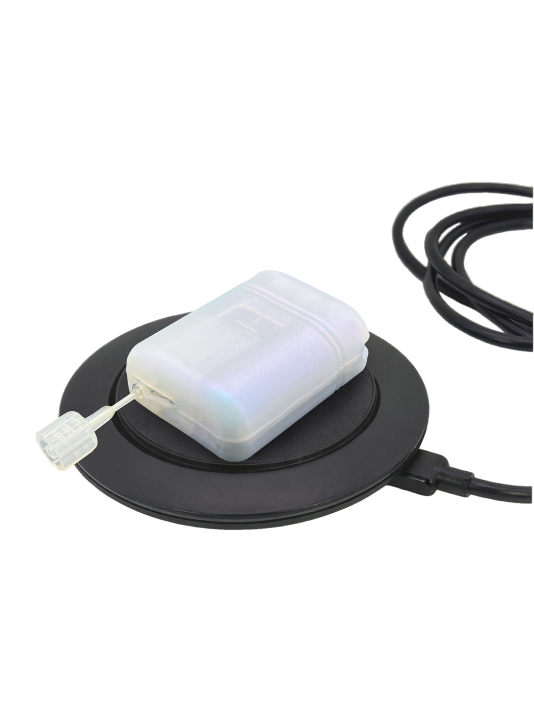 Mobi insulin pump with white gel skin resting on a circular charging base against a white background
