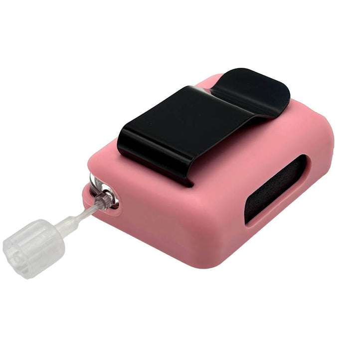 Pink Tandem Mobi EZ-To-Charge Clip with Mobi insulin pump inside the case, laying flat on a surface.