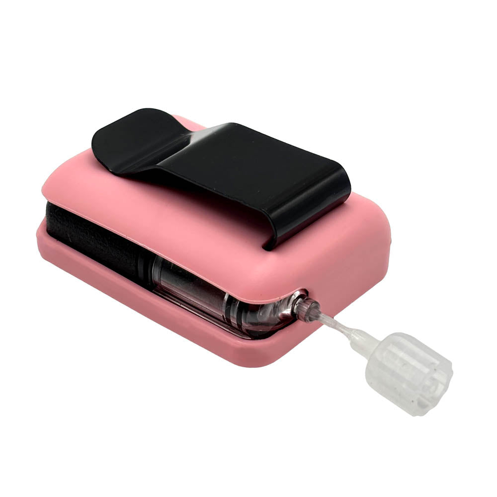 Pink Tandem Mobi EZ-To-Charge Clip with Mobi insulin pump inside the case, laying flat on a surface.