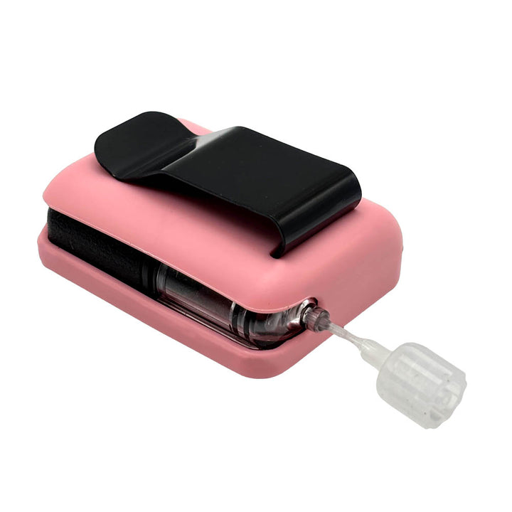 Pink Tandem Mobi EZ-To-Charge Clip with Mobi insulin pump inside the case, laying flat on a surface.
