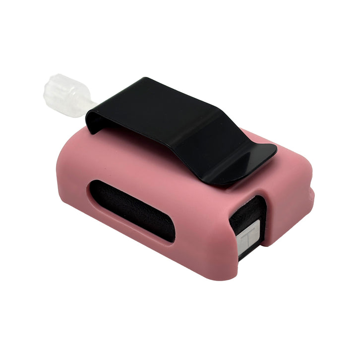 Pink Tandem Mobi EZ-To-Charge Clip with Mobi insulin pump inside the case, laying flat on a surface.