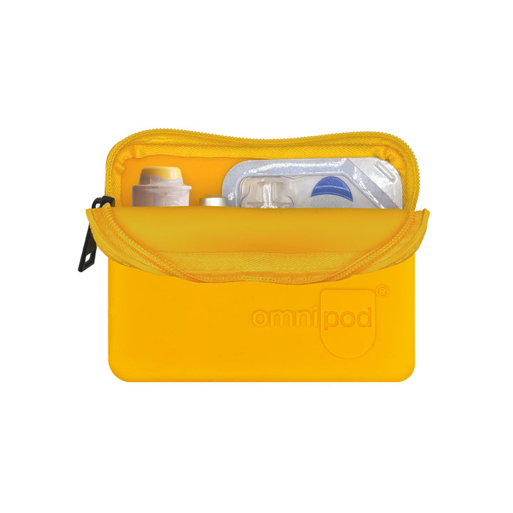 Set up with Omnipod® pod, insulin and Baqsimi nasal glucagon: The interior of the orange Omnipod® protective travel case showing an Omnipod® pod, insulin vial and a Baqsimi nasal glucagon arranged neatly within the case.
