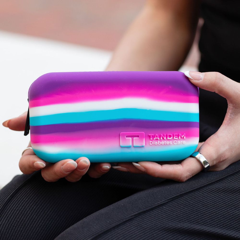 Person holding a colorful case with Tandem Diabetes Care logo