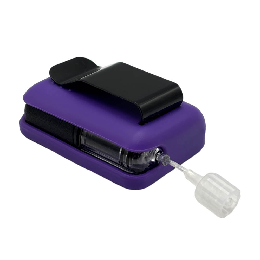Purple Tandem Mobi EZ-To-Charge Clip with Mobi insulin pump inside the case, laying flat on a surface.