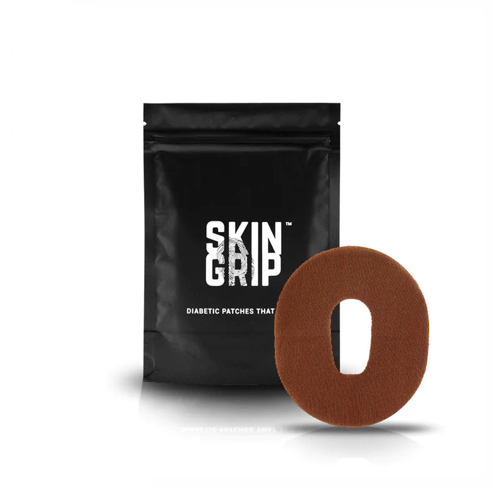 Black package that says Skin Grip which contains the adhesive patches and a chocolate brown adhesive patch designed to go around the Dexcom G6 sensor