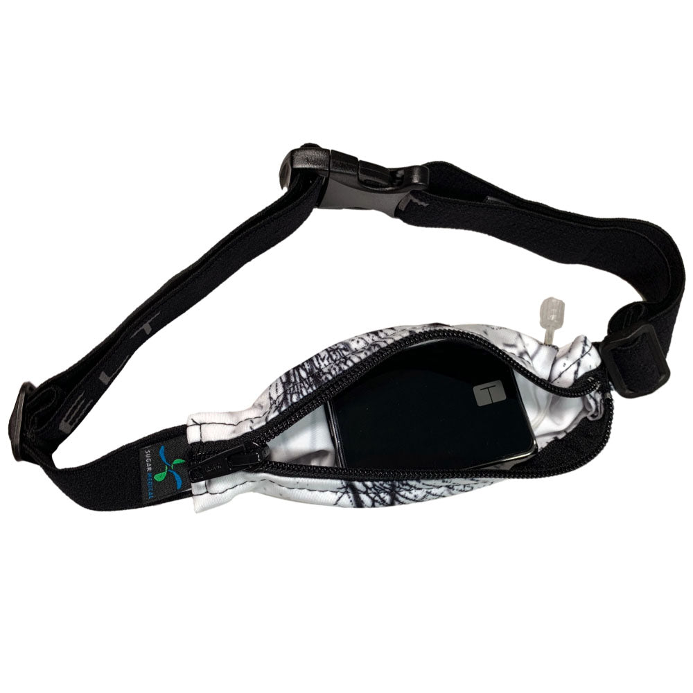 white stretchy waist belt with black granite pattern unzipped with insulin pump shown along with tubing coming out of the slit on the back side for easy access.