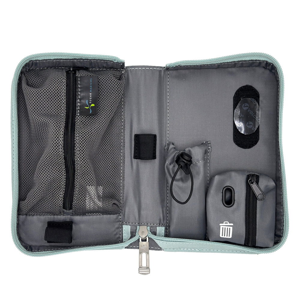 An open gray and black organizer pouch with multiple compartments, mesh pockets, elastic loops, and a small trash-compacting pocket, shown on a white background.