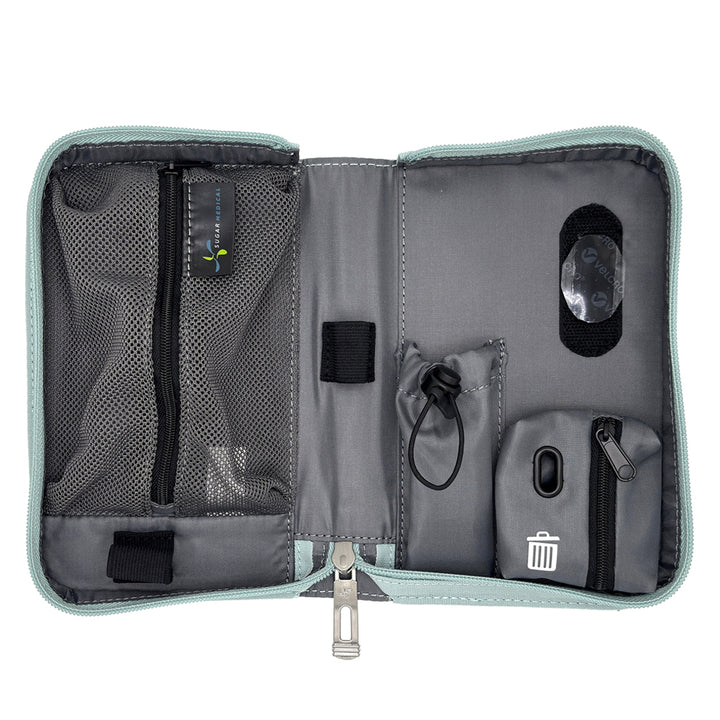 An open gray and black organizer pouch with multiple compartments, mesh pockets, elastic loops, and a small trash-compacting pocket, shown on a white background.
