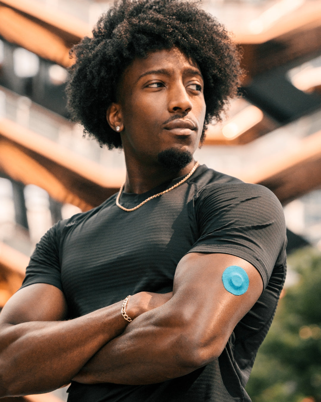 Man with a blue Skin Grip on his arm in an indoor setting