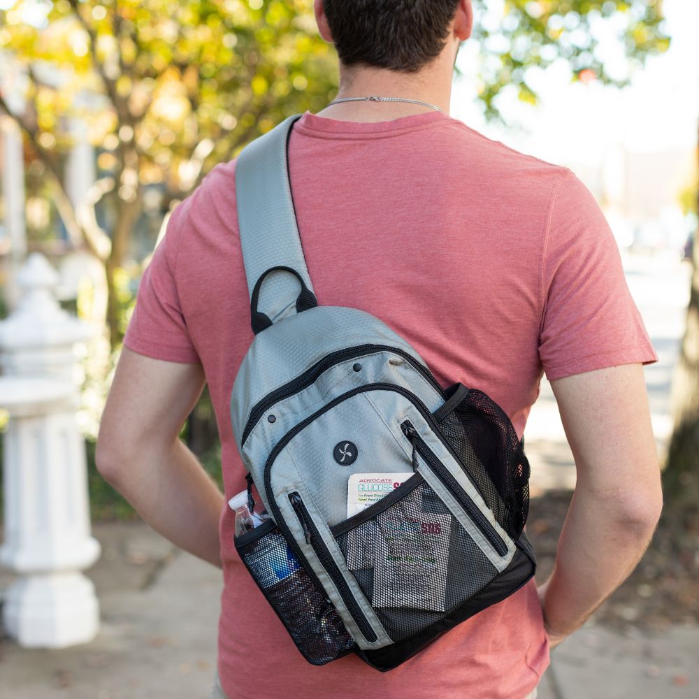 Diabetes Insulated Sling Backpack in grey on back of male model. 