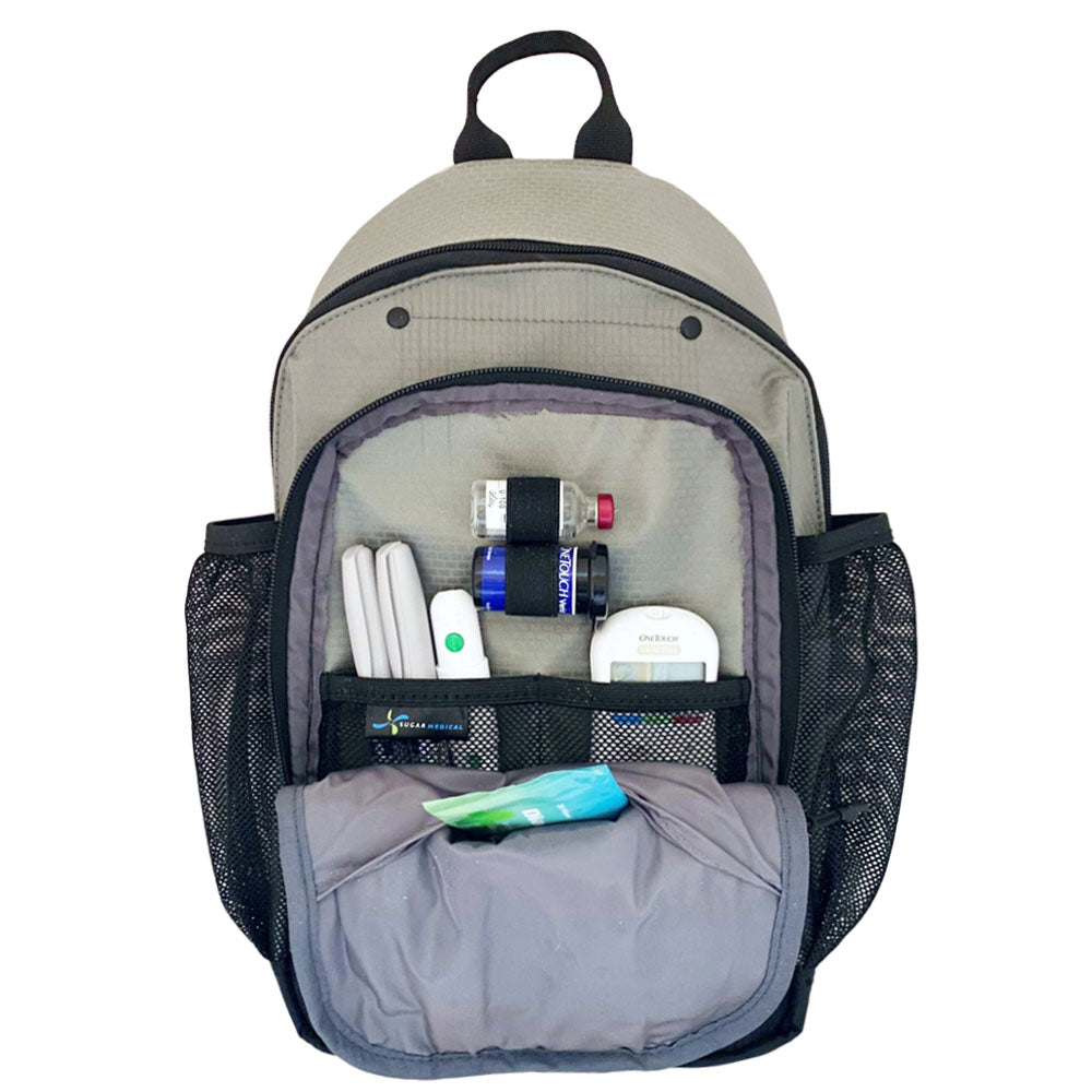 Diabetes Insulated Sling Backpack in grey front compartment set up with glucose meter, test strips, insulin pens and lancet. 