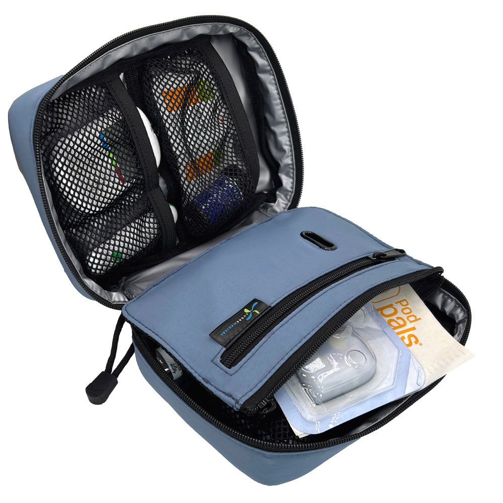 The front section of the steel blue diabetes organizer has three mesh pockets to secure your diabetic supplies